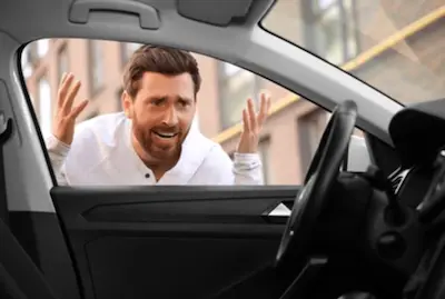 Auto locksmith unlocking a car after keys were locked inside